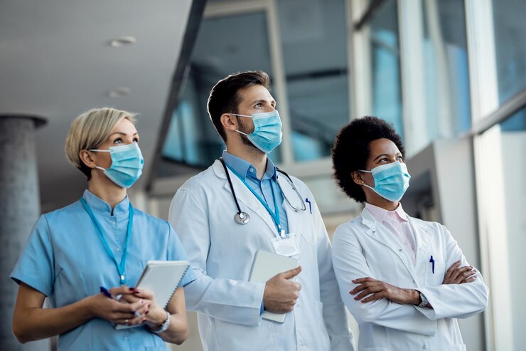 team-medical-experts-with-face-masks-hospital-coronavirus-pandemic_637285-11188